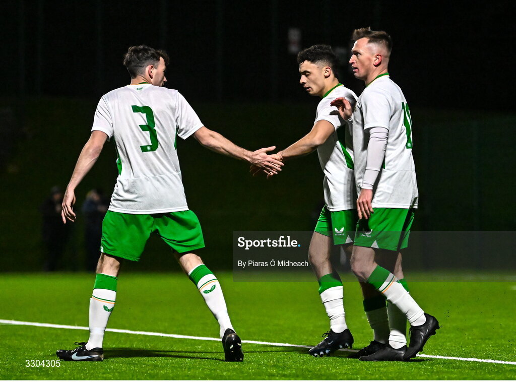 3 December 2025; Callum Lynch of Irish Defence Forces, second from right, celebrates with team-mate Dale Loughnane, 3, after scoring his side's first goal during the representative friendly match between Ireland Amateur and Irish Defence Forces at Wayside Celtic FC in Dublin. Photo by Piaras Ó Mídheach/Sportsfile