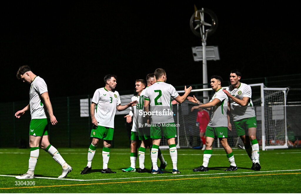 3 December 2025; Callum Lynch of Irish Defence Forces, second from right, celebrates with team-mate Aidan Friel, 2, after scoring his side's first goal during the representative friendly match between Ireland Amateur and Irish Defence Forces at Wayside Celtic FC in Dublin. Photo by Piaras Ó Mídheach/Sportsfile