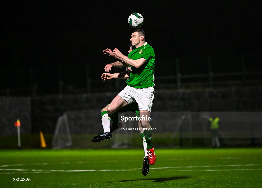 3 December 2025; Dean Walsh of Ireland Amateur, front, in action against Dale Loughnane of Irish Defence Forces during the representative friendly match between Ireland Amateur and Irish Defence Forces at Wayside Celtic FC in Dublin. Photo by Piaras Ó Mídheach/Sportsfile