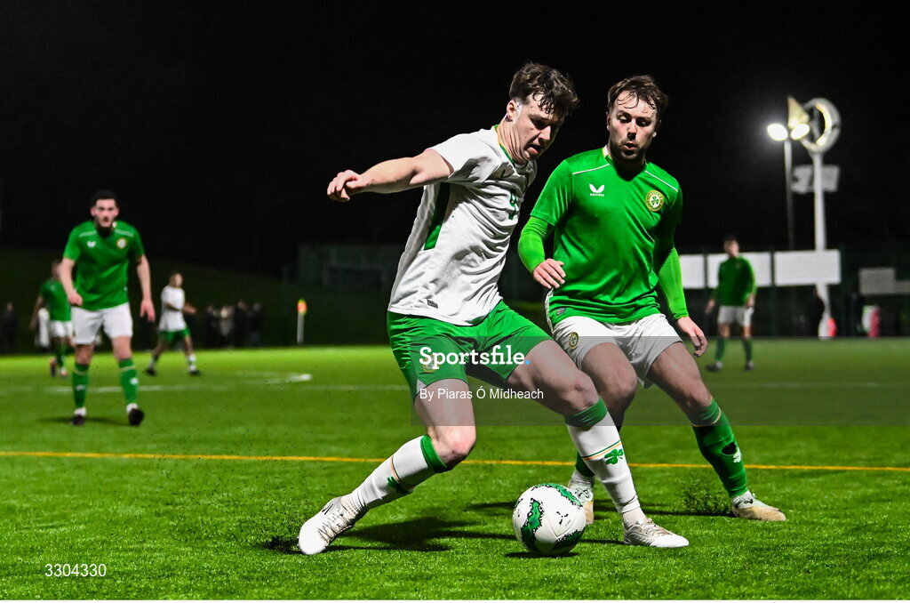 3 December 2025; Ronan Kierns of Irish Defence Forces, left, in action against Aaron O’Connor of Ireland Amateur during the representative friendly match between Ireland Amateur and Irish Defence Forces at Wayside Celtic FC in Dublin. Photo by Piaras Ó Mídheach/Sportsfile