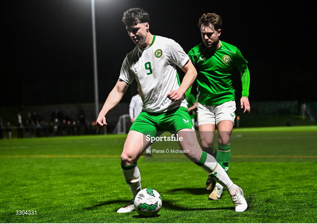 3 December 2025; Ronan Kierns of Irish Defence Forces, left, in action against Aaron O’Connor of Ireland Amateur during the representative friendly match between Ireland Amateur and Irish Defence Forces at Wayside Celtic FC in Dublin. Photo by Piaras Ó Mídheach/Sportsfile