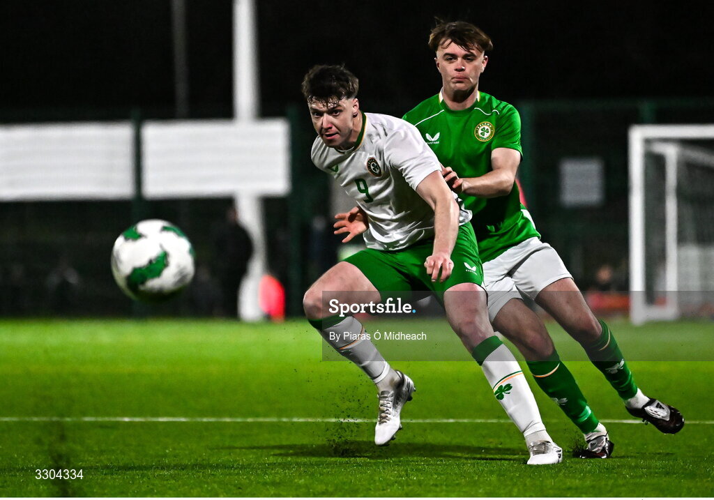 3 December 2025; Ronan Kierns of Irish Defence Forces, front, in action against Harvey Cullinan of Ireland Amateur during the representative friendly match between Ireland Amateur and Irish Defence Forces at Wayside Celtic FC in Dublin. Photo by Piaras Ó Mídheach/Sportsfile