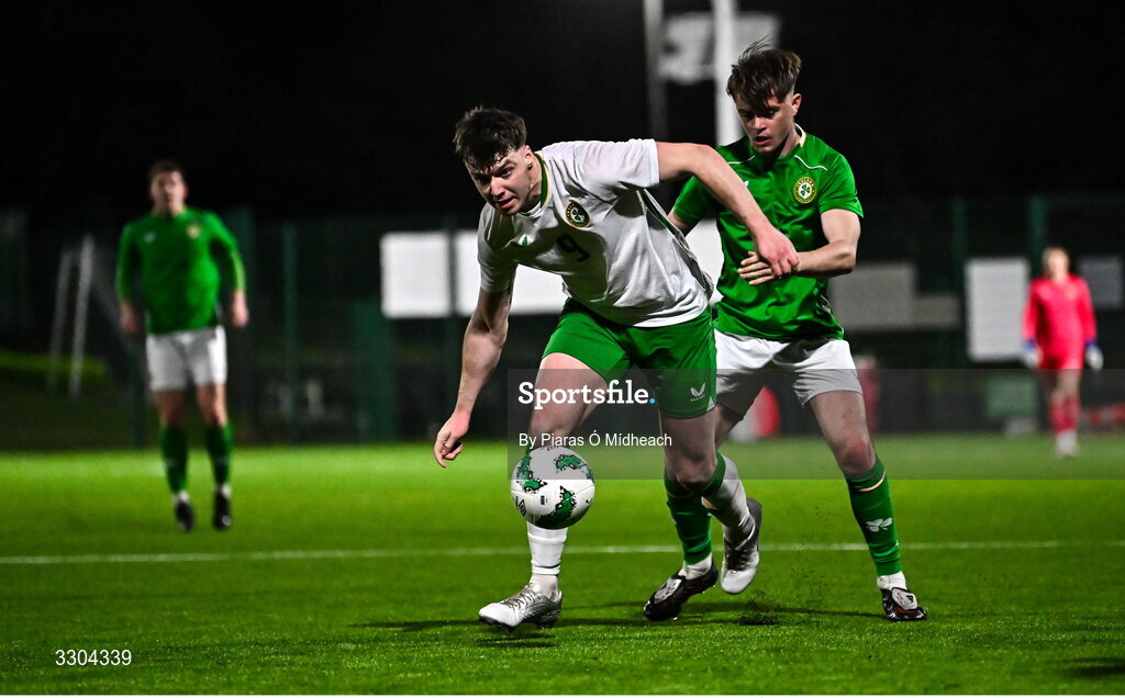 3 December 2025; Ronan Kierns of Irish Defence Forces, front, in action against Harvey Cullinan of Ireland Amateur during the representative friendly match between Ireland Amateur and Irish Defence Forces at Wayside Celtic FC in Dublin. Photo by Piaras Ó Mídheach/Sportsfile