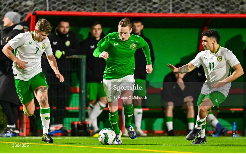 3 December 2025; Jimmy Carr of Ireland Amateur in action against Luke Parke, 7, and Callum Lynch of Irish Defence Forces during the representative friendly match between Ireland Amateur and Irish Defence Forces at Wayside Celtic FC in Dublin. Photo by Piaras Ó Mídheach/Sportsfile