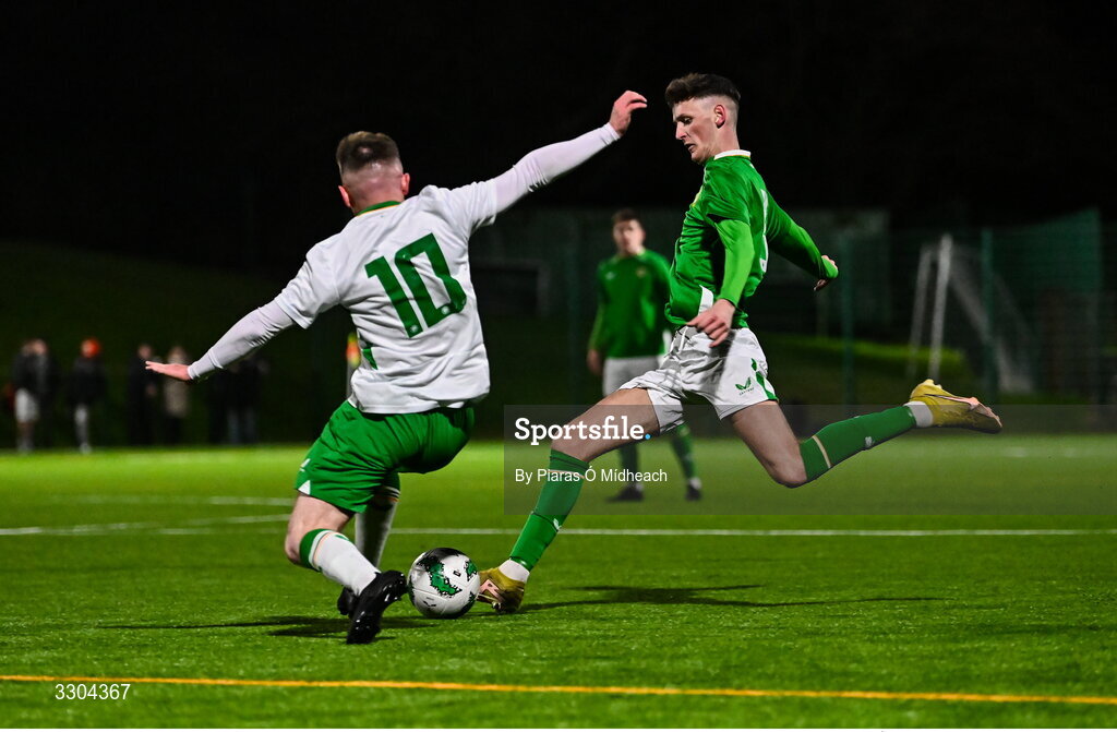 3 December 2025; Adam Delurey of Ireland Amateur in action against Adrian Rafferty of Irish Defence Forces, 10, during the representative friendly match between Ireland Amateur and Irish Defence Forces at Wayside Celtic FC in Dublin. Photo by Piaras Ó Mídheach/Sportsfile