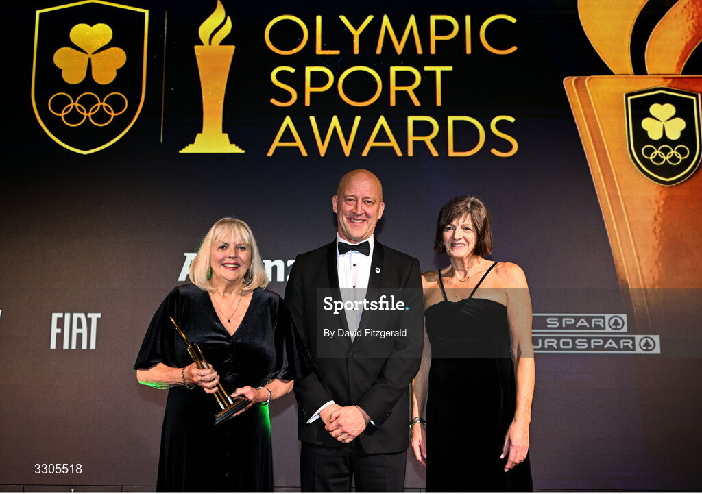 6 December 2025; Shauna Kyle, representing her mother Maeve Kyle, left, and Carolyn Burns, goddaughter of Maeve Kyle, right, are presented with the President's Award, by Lochlann Walsh, President of Olympic Federation of Ireland during the Team Ireland Olympic Sport Awards 2025 at The Royal Convention Centre in Dublin. Photo by David Fitzgerald/Sportsfile