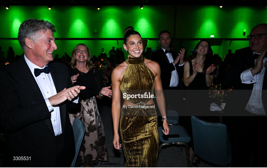 6 December 2025; World Silver Medallist in Heptathlon Kate O'Connor passes her father and coach Michael O'Connor as she makes her way to the stage to collect her Female Athlete of the Year Award, sponsored by Allianz,  during the Team Ireland Olympic Sport Awards 2025 at The Royal Convention Centre in Dublin. Photo by David Fitzgerald/Sportsfile
