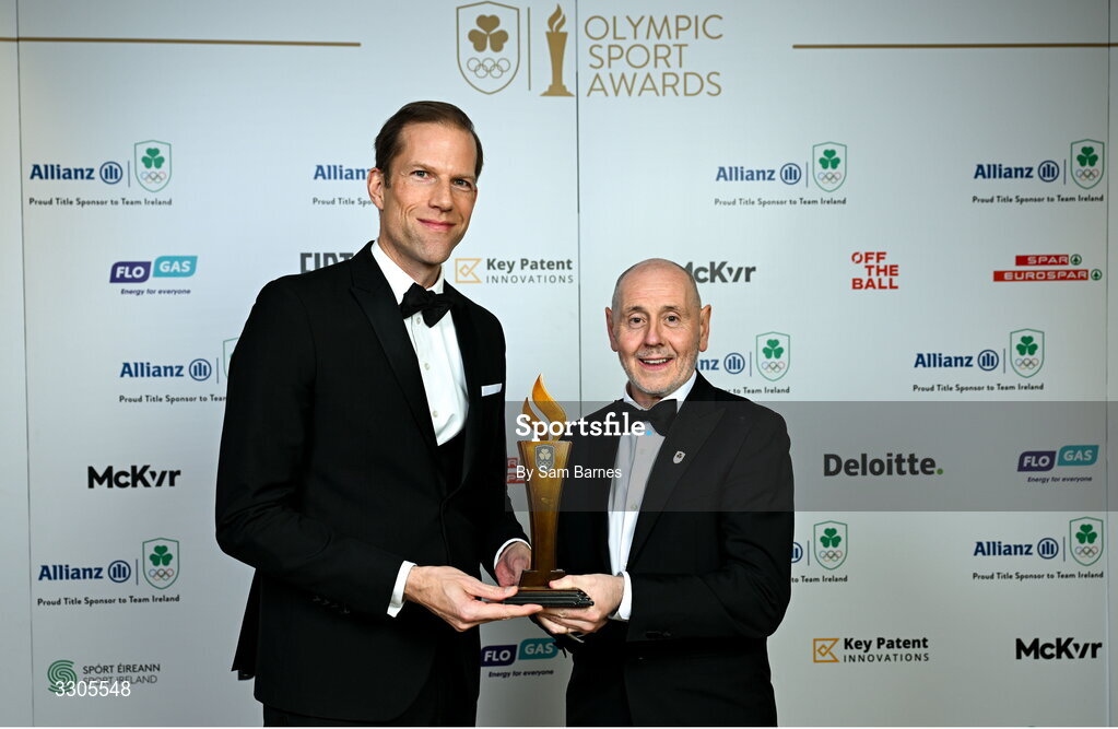 6 December 2025; Brian McIlroy, right, representing his nephew Rory McIlroy, is presented with the Male Athlete of the Year Award, sponsored by Allianz, by Phillip Gronemeyer, Chief Executive of Allianz Ireland,  during the Team Ireland Olympic Sport Awards 2025 at The Royal Convention Centre in Dublin. Photo by Sam Barnes/Sportsfile