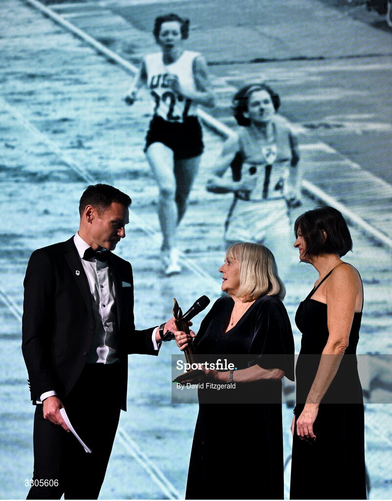6 December 2025; Shauna Kyle, centre, representing her mother Maeve Kyle, and Carolyn Burns, right, goddaughter of Maeve Kyle, are interviewed by MC David Gillick, after collecting the President's Award during the Team Ireland Olympic Sport Awards 2025 at The Royal Convention Centre in Dublin. Photo by David Fitzgerald/Sportsfile