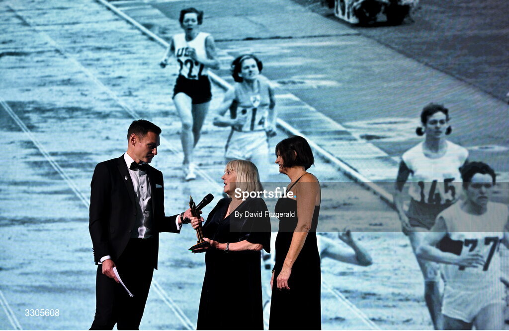 6 December 2025; Shauna Kyle, centre, representing her mother Maeve Kyle, and Carolyn Burns, right, goddaughter of Maeve Kyle, are interviewed by MC David Gillick, after collecting the President's Award during the Team Ireland Olympic Sport Awards 2025 at The Royal Convention Centre in Dublin. Photo by David Fitzgerald/Sportsfile