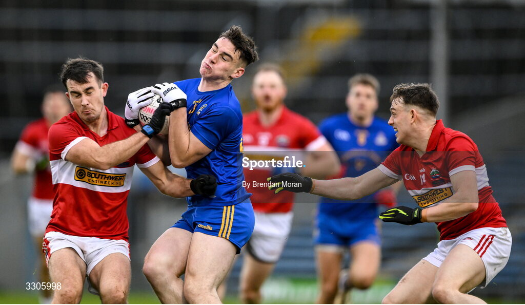 7 December 2025; Rickey Barrett of St Finbarr's is tackled by Aidan O'Connor, left, and Matthew Flaherty of Dingle during the AIB Munster GAA Football Senior Club Championship final match between Dingle and St Finbarr's at FBD Semple Stadium in Thurles, Tipperary. Photo by Brendan Moran/Sportsfile