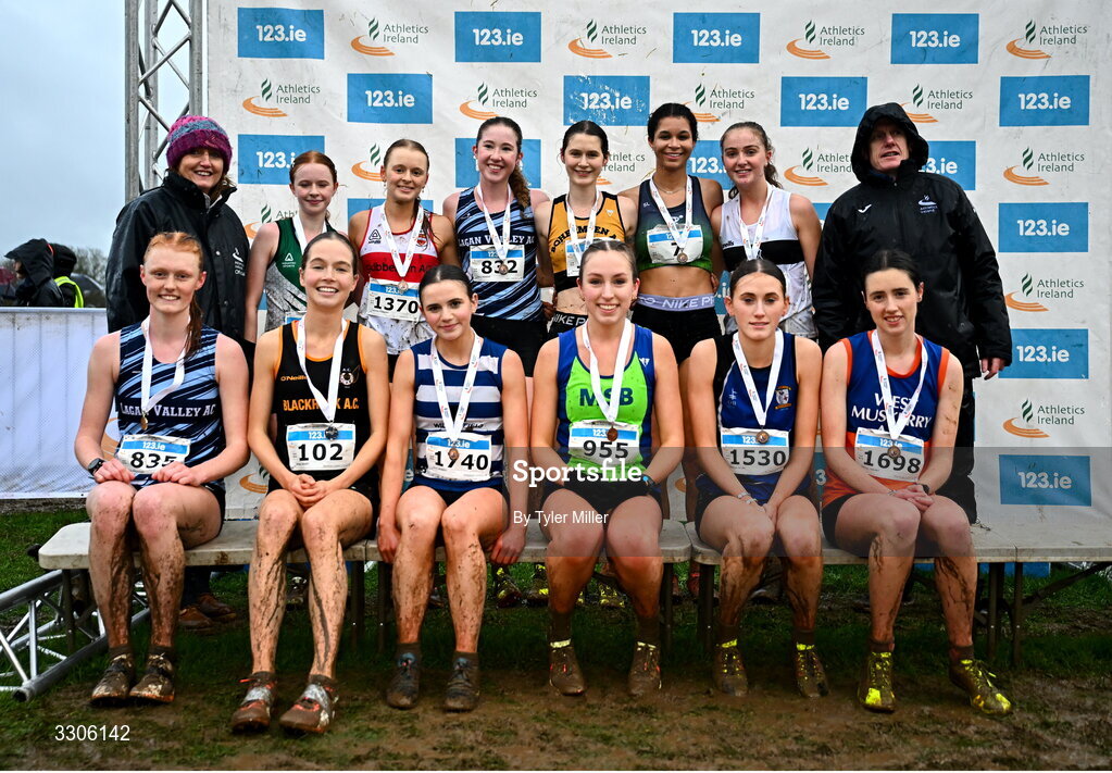 7 December 2025; U19 Girls 5000m top twelve with Athletics Ireland President Brid Golden, left, and Chief Executive Officer at Intact Insurance Ireland Kevin Thompson, right, after competing in the U19 Girls 5000m during the 123.ie National Novice and Juvenile Uneven Age Cross Country Championships at the Sport Ireland National Cross Country Track in Abbotstown, Dublin. Photo by Tyler Miller/Sportsfile