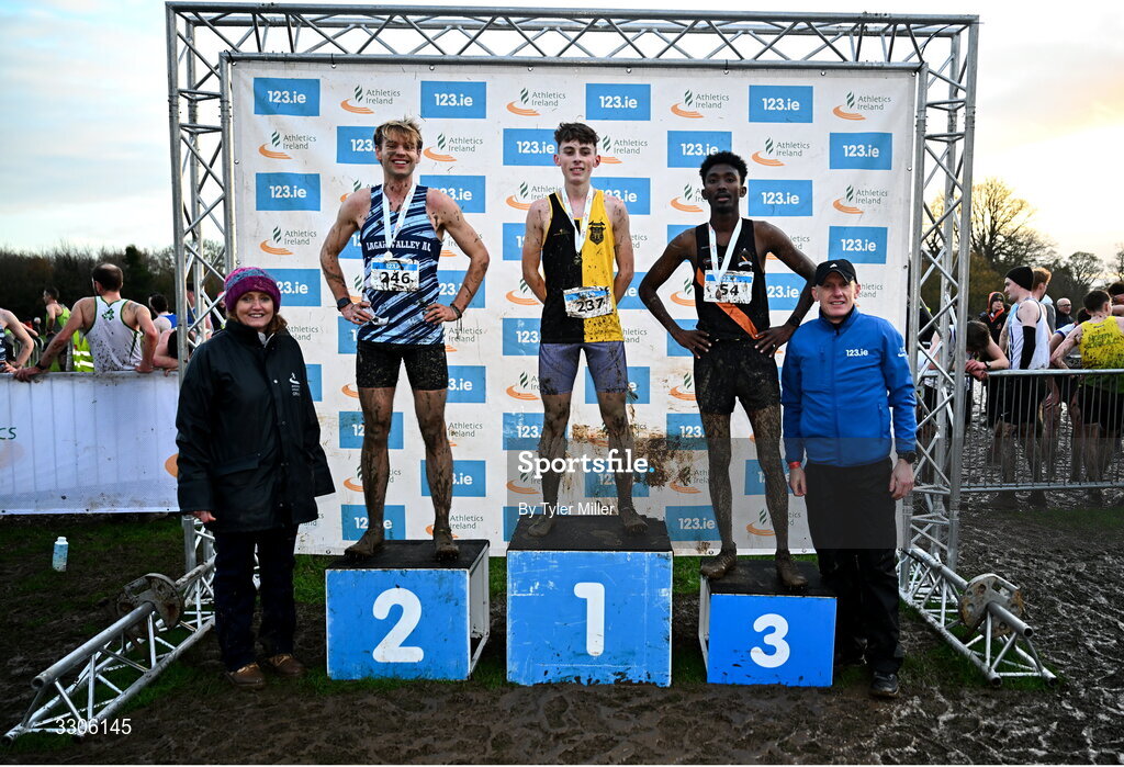 7 December 2025; Novice Men 6000m medalists, from second from left, Stephen Lyster of Lagan Valley AC, Antrim, silver Callum Barron of Kilkenny City Harriers AC, Kilkenny, gold, and Mahad Mohamed Egaal of Clonliffe Harriers AC, Dublin, bronze, with Athletics Ireland President Brid Golden, left, and Chief Executive Officer at Intact Insurance Ireland Kevin Thompson, after competing in the Novice Men 6000m during the 123.ie National Novice and Juvenile Uneven Age Cross Country Championships at the Sport Ireland National Cross Country Track in Abbotstown, Dublin. Photo by Tyler Miller/Sportsfile