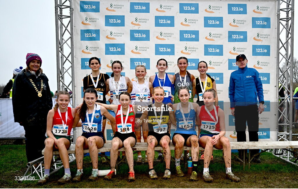 7 December 2025; U17 Girls 4500m top twelve with Athletics Ireland President Brid Golden, left, and Chief Executive Officer at Intact Insurance Ireland Kevin Thompson, right, during the 123.ie National Novice and Juvenile Uneven Age Cross Country Championships at the Sport Ireland National Cross Country Track in Abbotstown, Dublin.     Photo by Tyler Miller/Sportsfile