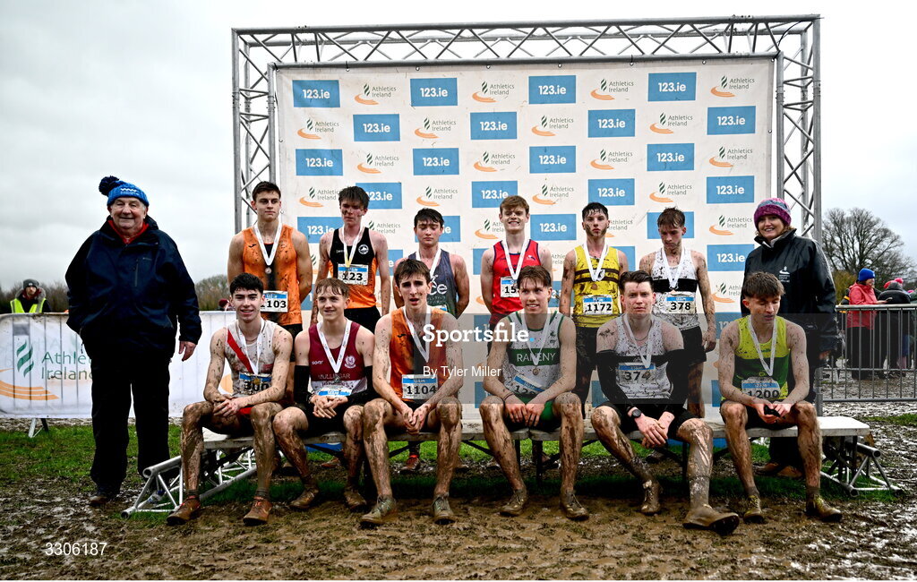7 December 2025; U19 Boys 5000m top twelve with Eamonn Giles, far left, coach of race winner Caolan Mcfadden, bottom left, and Athletics Ireland President Brid Golden during the 123.ie National Novice and Juvenile Uneven Age Cross Country Championships at the Sport Ireland National Cross Country Track in Abbotstown, Dublin. Photo by Tyler Miller/Sportsfile