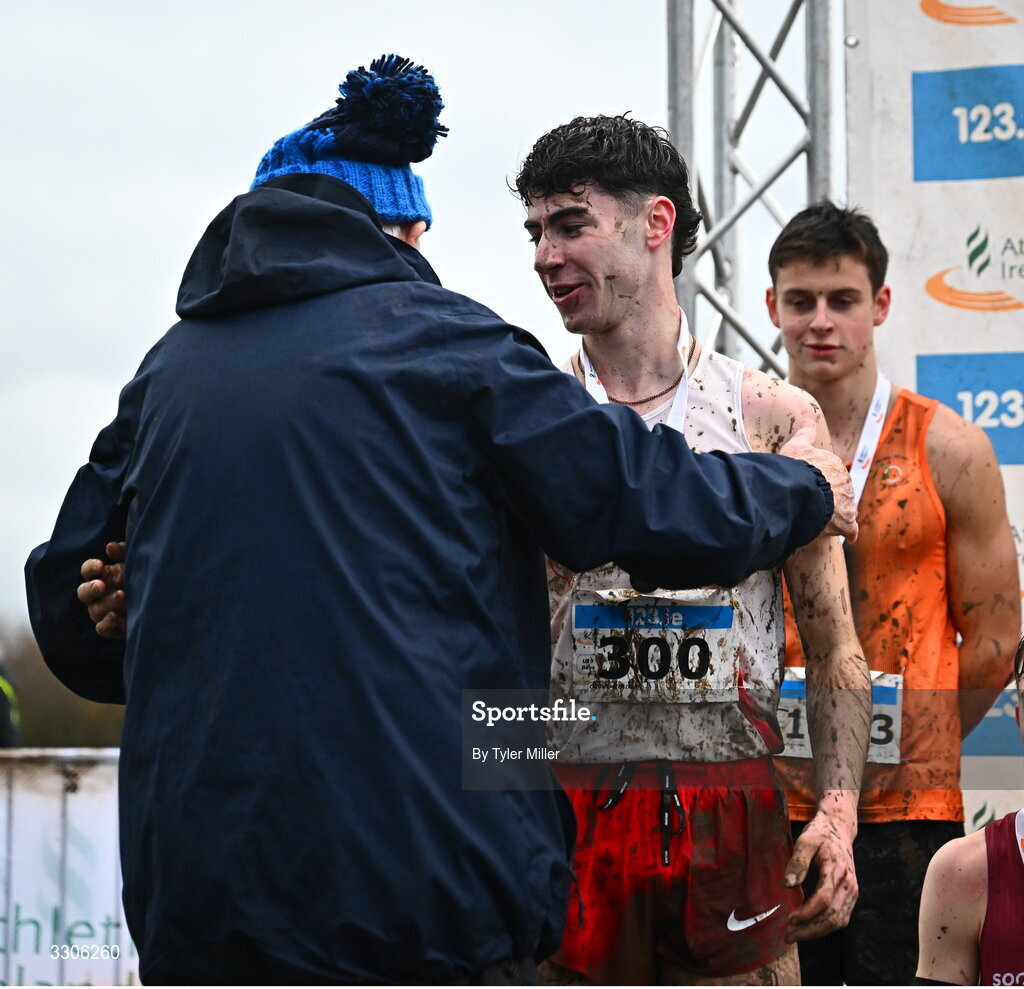 7 December 2025; Caolan McFadden of Cranford AC, Donegal, with coach Eamonn Giles after competing and winning the U19 Boys 5000m during the 123.ie National Novice and Juvenile Uneven Age Cross Country Championships at the Sport Ireland National Cross Country Track in Abbotstown, Dublin. Photo by Tyler Miller/Sportsfile