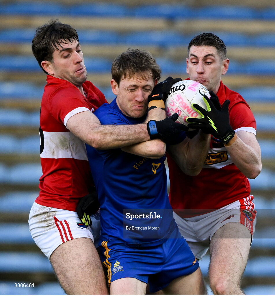7 December 2025; Sam Ryan of St Finbarr's is tackled by Conor Geaney, left, and Paul Geaney of Dingle during the AIB Munster GAA Football Senior Club Championship final match between Dingle and St Finbarr's at FBD Semple Stadium in Thurles, Tipperary. Photo by Brendan Moran/Sportsfile
