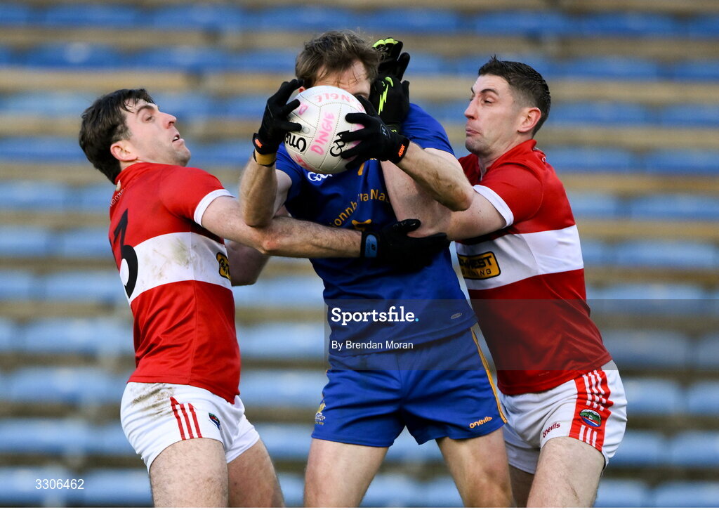 7 December 2025; Sam Ryan of St Finbarr's is tackled by Conor Geaney, left, and Paul Geaney of Dingle during the AIB Munster GAA Football Senior Club Championship final match between Dingle and St Finbarr's at FBD Semple Stadium in Thurles, Tipperary. Photo by Brendan Moran/Sportsfile