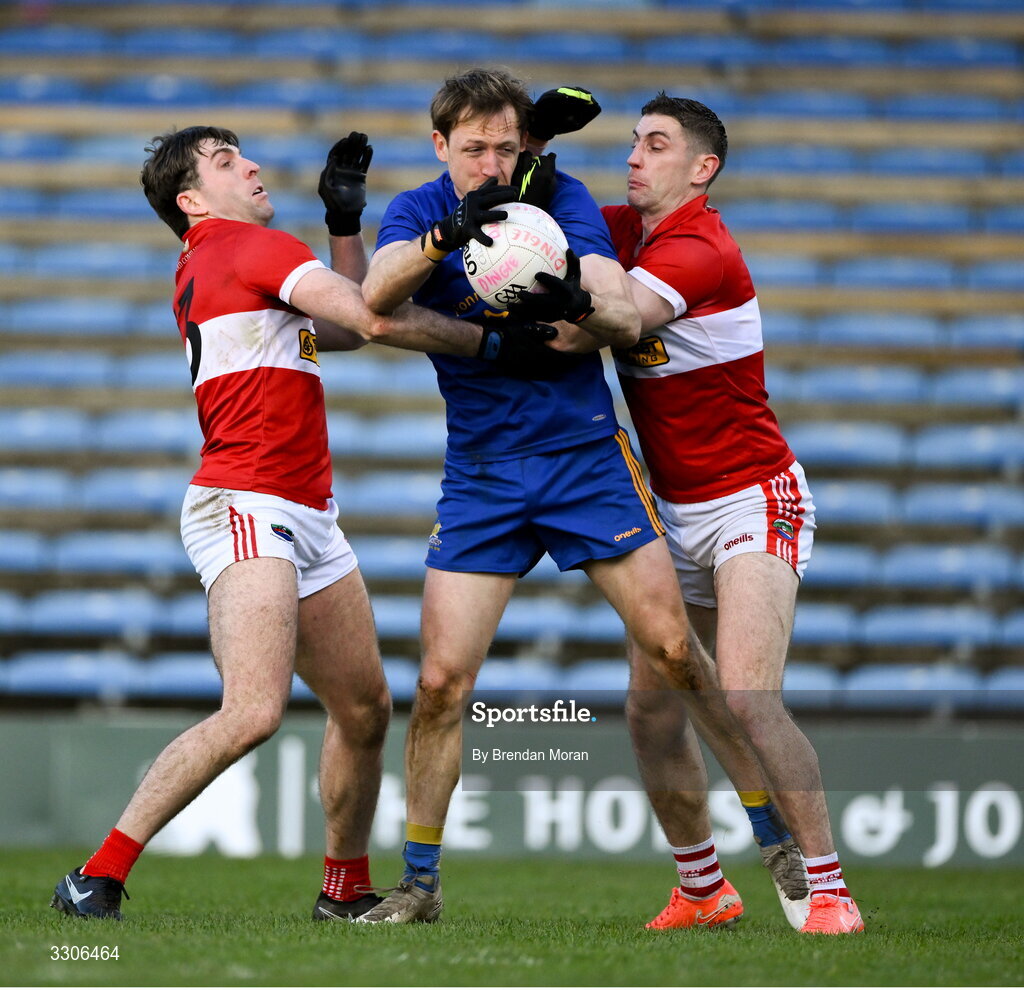 7 December 2025; Sam Ryan of St Finbarr's is tackled by Conor Geaney, left, and Paul Geaney of Dingle during the AIB Munster GAA Football Senior Club Championship final match between Dingle and St Finbarr's at FBD Semple Stadium in Thurles, Tipperary. Photo by Brendan Moran/Sportsfile