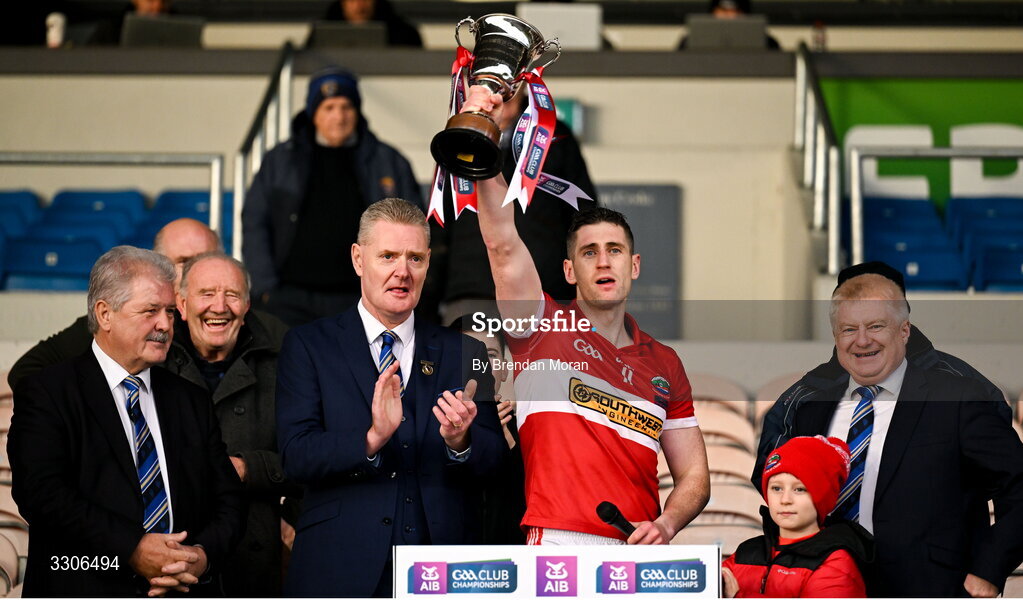 7 December 2025; Dingle captain Paul Geaney lifts the cup, in the company of Munster Council officials, from left, treasurer Bob Ryan, chairman Tom Murphy and PRO Dermot Lynch, after the AIB Munster GAA Football Senior Club Championship final match between Dingle and St Finbarr's at FBD Semple Stadium in Thurles, Tipperary. Photo by Brendan Moran/Sportsfile