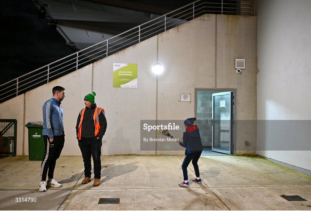 2 January 2026; Tipperary manager Niall Fitzgerald, left, in coversation with event steward Hammy Dawson, from St Patrick's GAA club, Limerick, as his son Danny Fitzgerald, age 9, keeps himself entertained before the McGrath Cup match between Limerick and Tipperary at Mick Neville Park in Rathkeale, Limerick. Photo by Brendan Moran/Sportsfile