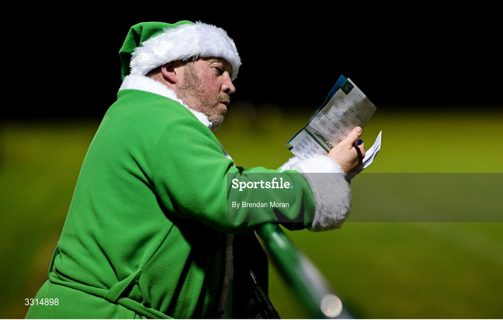 2 January 2026; Limerick supporter Pat Carroll, from Croom in Limerick, wearing a green Santa Claus outfit to keep warm, checks his match programme during the McGrath Cup match between Limerick and Tipperary at Mick Neville Park in Rathkeale, Limerick. Photo by Brendan Moran/Sportsfile