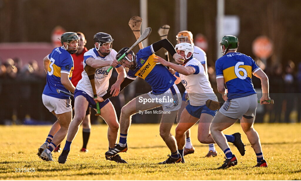 3 January 2026; Josh Keller of Tipperary is tackled by Joe Booth, left, and Reuben Halloran of Waterford during the Co-Op Superstores Munster Senior Hurling League match between Tipperary and Waterford at Fethard Town Park in Fethard, Tipperary. Photo by Ben McShane/Sportsfile
