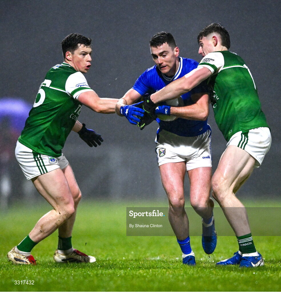 7 January 2026; Peter Corrigan of Cavan is tackled by Fermanagh players Gary McKenna, left, and Darragh McGurn during the Bank of Ireland Dr McKenna Cup match between Fermanagh and Cavan at St Patrick's Park in Tempo, Fermanagh. Photo by Shauna Clinton/Sportsfile