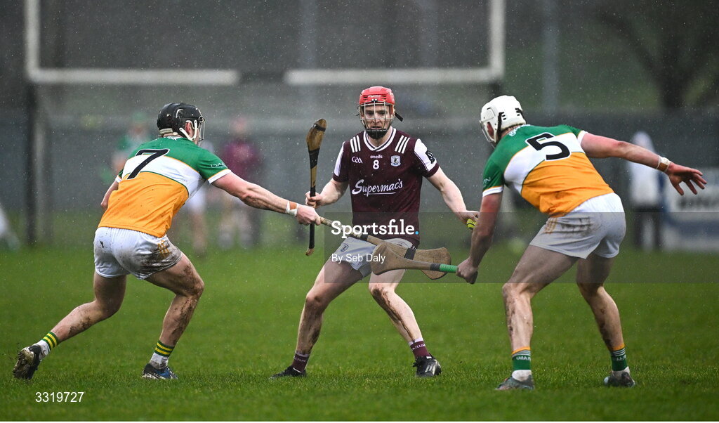 11 January 2026; Tom Monaghan of Galway in action against Offaly players Dan Ravenhill, left, and Eimhin Kelly during the Dioralyte Walsh Cup semi-final match between Galway and Offaly at Duggan Park in Ballinasloe, Galway. Photo by Seb Daly/Sportsfile