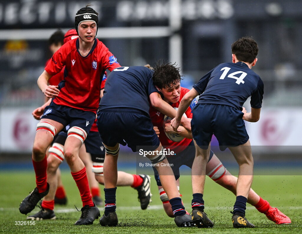 22 January 2026; Ruairí O'Gorman of CUS is tackled by Henry Shackleton of Wesley College during the Bank of Ireland Leinster Rugby Boys Schools Fr Godfrey Cup semi-final match between Wesley College and CUS at Energia Park in Dublin. Photo by Shauna Clinton/Sportsfile