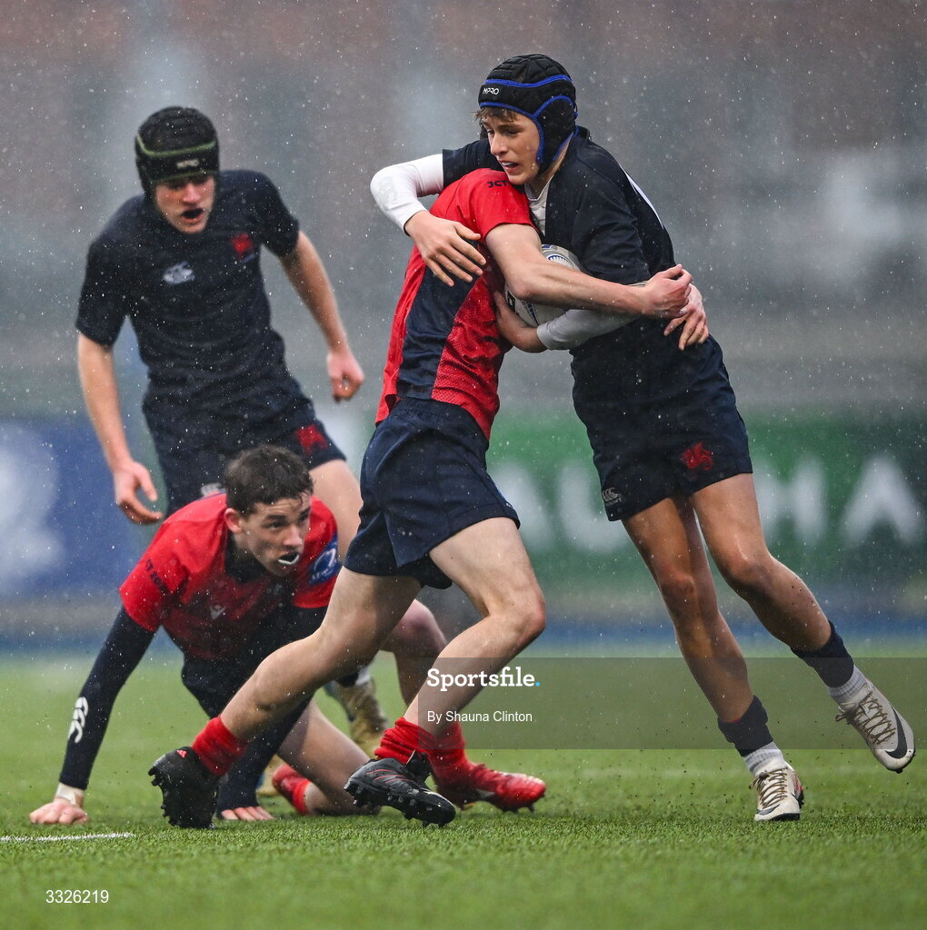 22 January 2026; Luke Hamilton of Wesley College is tackled by Leonard Deering of CUS during the Bank of Ireland Leinster Rugby Boys Schools Fr Godfrey Cup semi-final match between Wesley College and CUS at Energia Park in Dublin. Photo by Shauna Clinton/Sportsfile