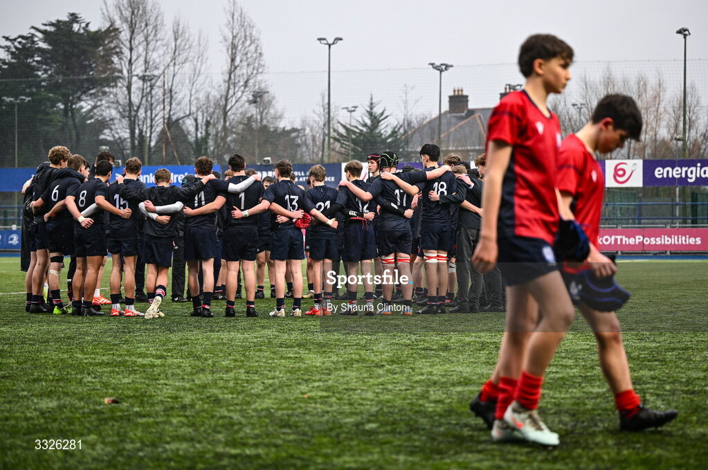 22 January 2026; Wesley College players huddle as CUS players leave the pitch dejecetd after his side's defeat in the Bank of Ireland Leinster Rugby Boys Schools Fr Godfrey Cup semi-final match between Wesley College and CUS at Energia Park in Dublin. Photo by Shauna Clinton/Sportsfile