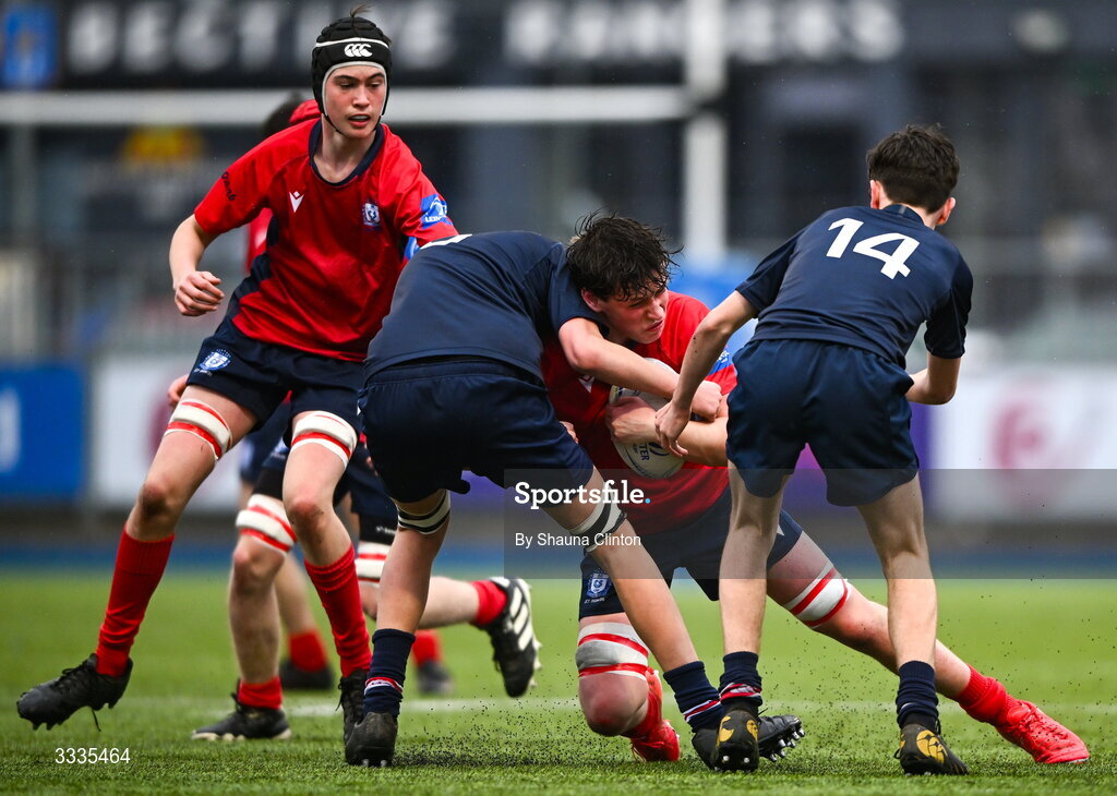 22 January 2026; Ruairí O'Gorman of CUS is tackled by Welsey players Henry Shackleton, left, and Teddy Mitchell during the Bank of Ireland Leinster Rugby Boys Schools Fr Godfrey Cup semi-final match between Wesley College and CUS at Energia Park in Dublin. Photo by Shauna Clinton/Sportsfile