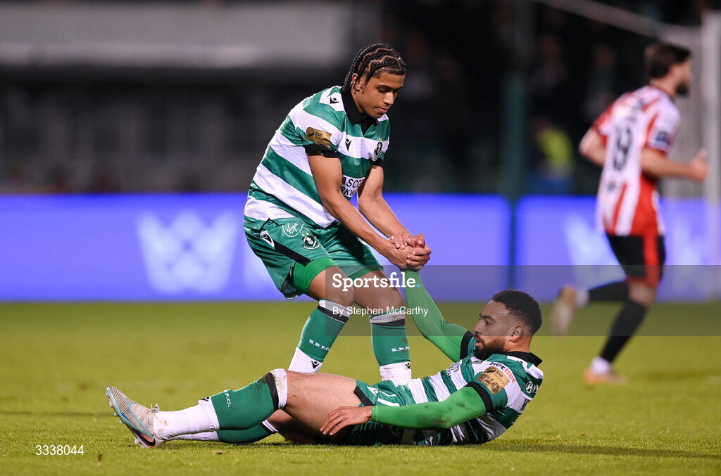 31 January 2026; Jake Mulraney is helped up by Shamrock Rovers team-mate Victor Ozhianvuna during the 2026 Men's President's Cup final match between Shamrock Rovers and Derry City at Tallaght Stadium in Dublin. Photo by Stephen McCarthy/Sportsfile