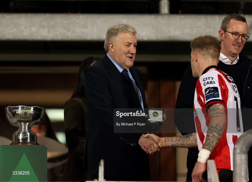 31 January 2026; James McClean of Derry City recieves his winners medal from FAI President Paul Cooke after the 2026 Men's President's Cup final match between Shamrock Rovers and Derry City at Tallaght Stadium in Dublin. Photo by Michael P Ryan/Sportsfile