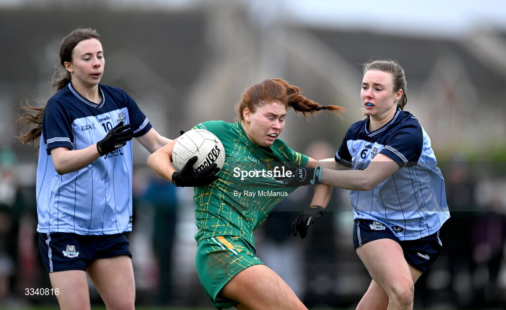 2 February 2026; Ciara Smyth of Meath is tackled by Hannah Leahy and Sophie McIntyre of Dublin, left, during the Lidl Ladies National Football League Division 1 Round 2 match between Meath and Dublin at St Patrick’s GFC in Stamullen, Meath. Photo by Ray McManus/Sportsfile