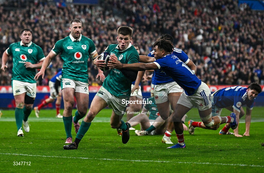 5 February 2026; Sam Prendergast of Ireland is tackled by Théo Attissogbe of France during the Guinness 6 Nations Rugby Championship match between France and Ireland at Stade de France in Paris, France. Photo by Ramsey Cardy/Sportsfile
