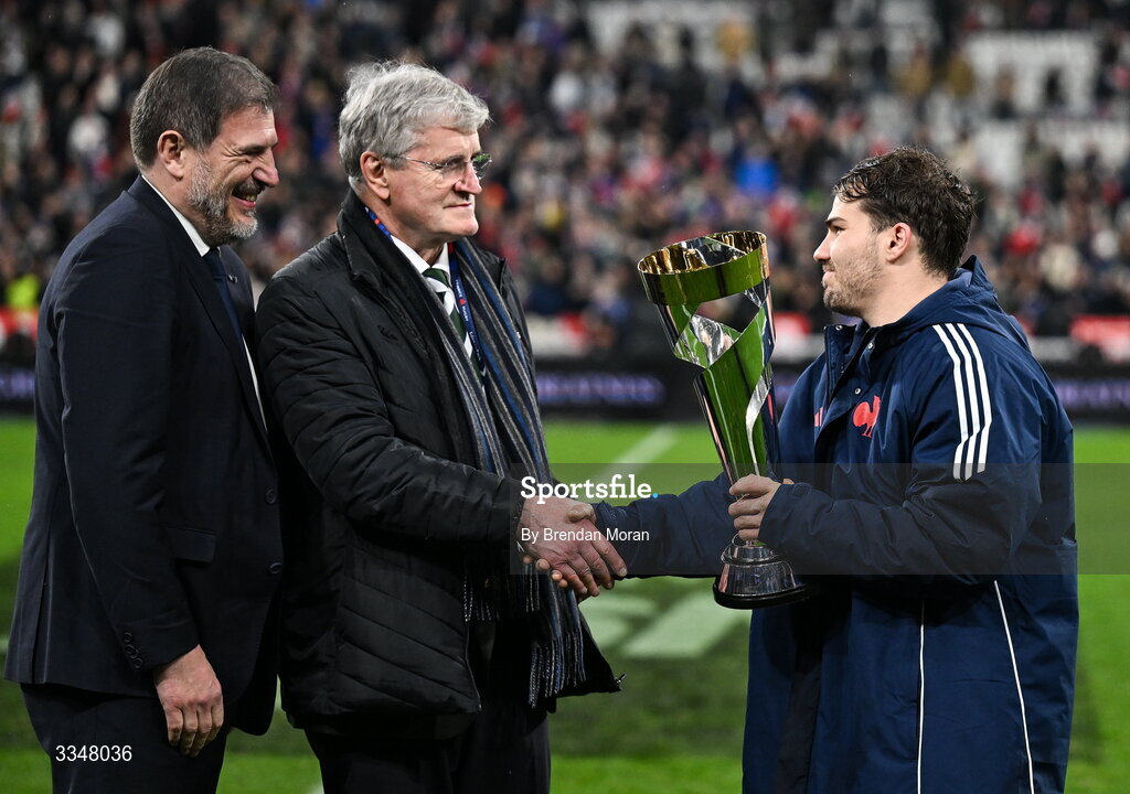 5 February 2026; France captain Antoine Dupont is presented with the Solidarity Cup by IRFU president John O'Driscoll, in the company of FFR president Florian Grill, after the Guinness 6 Nations Rugby Championship match between France and Ireland at Stade de France in Paris, France. Photo by Brendan Moran/Sportsfile