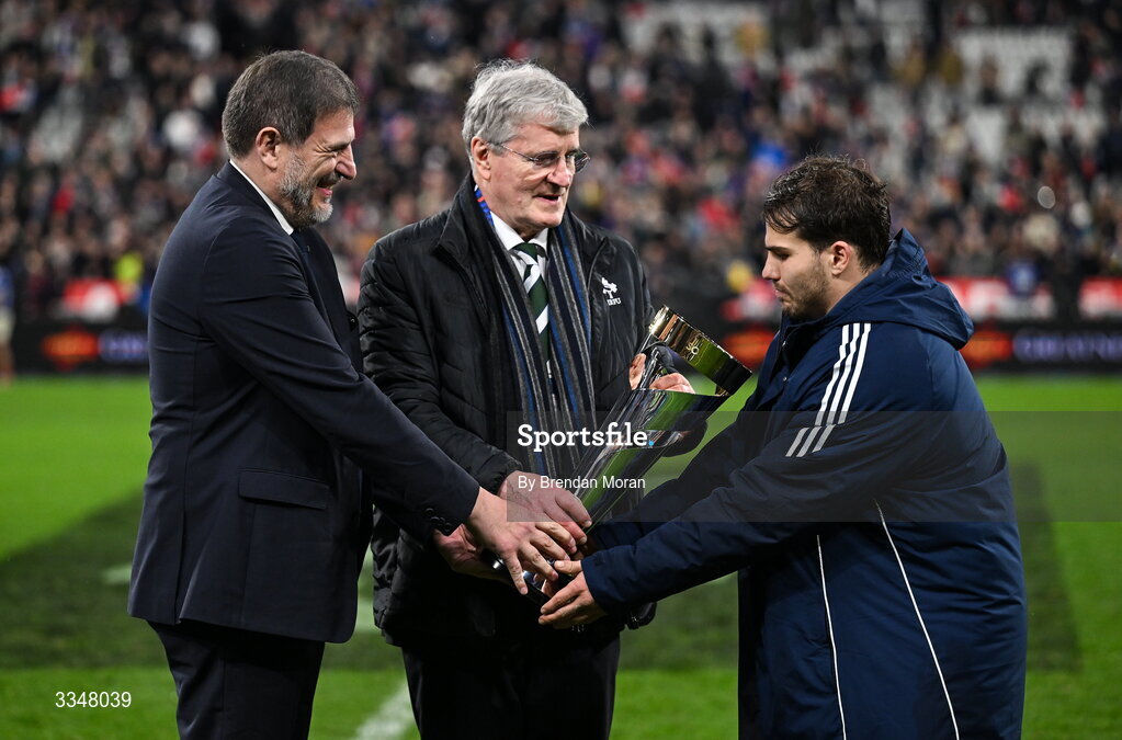 5 February 2026; France captain Antoine Dupont is presented with the Solidarity Cup by IRFU president John O'Driscoll and FFR president Florian Grill after the Guinness 6 Nations Rugby Championship match between France and Ireland at Stade de France in Paris, France. Photo by Brendan Moran/Sportsfile