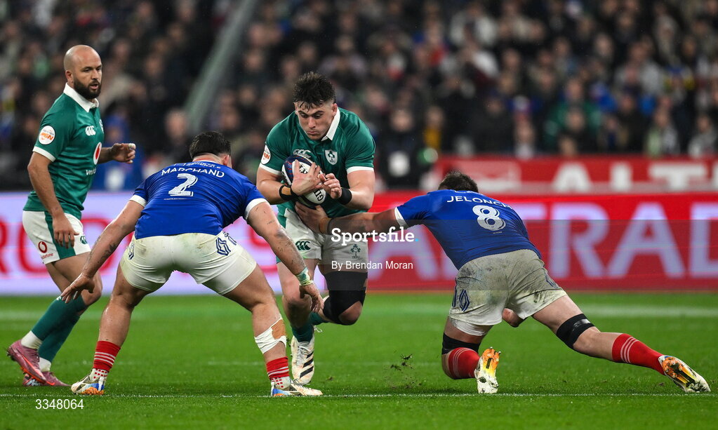 5 February 2026; Dan Sheehan of Ireland is tackled by France players Julien Marchand, left, and Anthony Jelonch during the Guinness 6 Nations Rugby Championship match between France and Ireland at Stade de France in Paris, France. Photo by Brendan Moran/Sportsfile