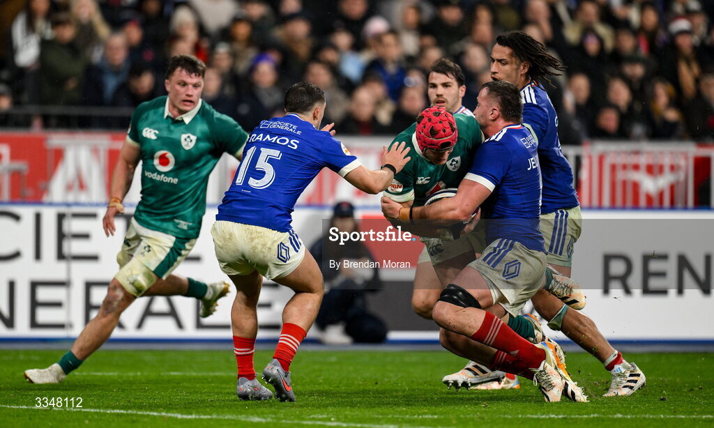 5 February 2026; Josh van der Flier of Ireland is tackled by Thomas Ramos, left, and Anthony Jelonch of France during the Guinness 6 Nations Rugby Championship match between France and Ireland at Stade de France in Paris, France. Photo by Brendan Moran/Sportsfile