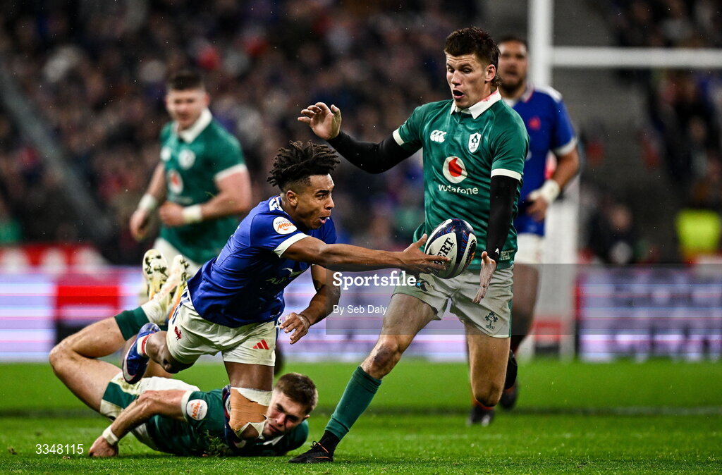 5 February 2026; Théo Attissogbe of France is tackled by Jack Crowley and Sam Prendergast of Ireland during the Guinness 6 Nations Rugby Championship match between France and Ireland at Stade de France in Paris, France. Photo by Seb Daly/Sportsfile