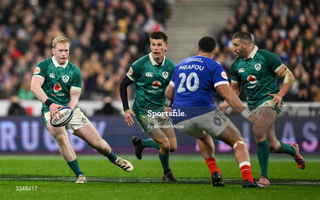 5 February 2026; Jamie Osborne of Ireland passes to teammate Stuart McCloskey, right, during the Guinness 6 Nations Rugby Championship match between France and Ireland at Stade de France in Paris, France. Photo by Brendan Moran/Sportsfile