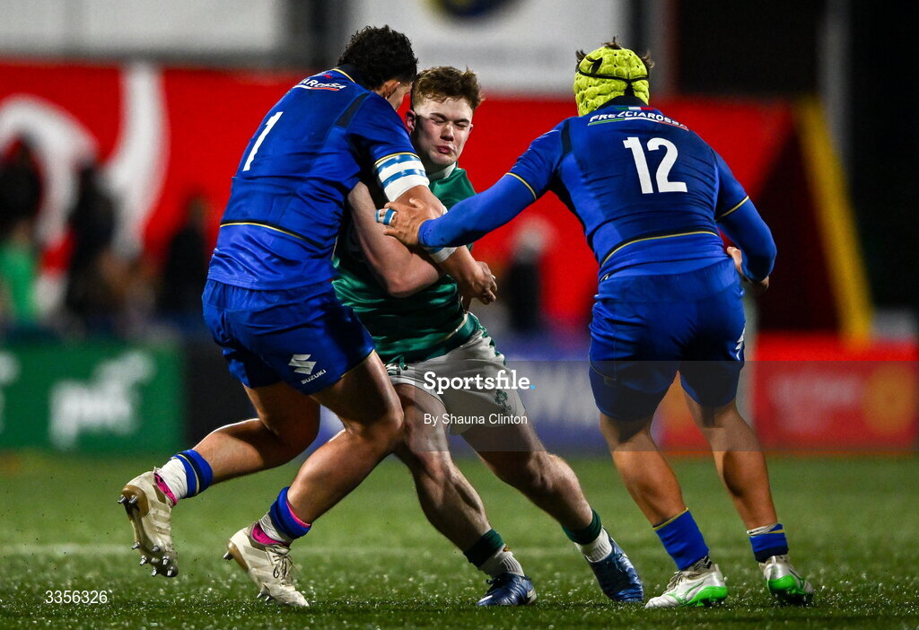 13 February 2026; James O'Leary of Ireland is tackled by Italy players Christian Brasini, left, and Riccardo Casarin during the U20 Six Nations Rugby Championship match between Ireland and Italy at Virgin Media Park in Cork. Photo by Shauna Clinton/Sportsfile
