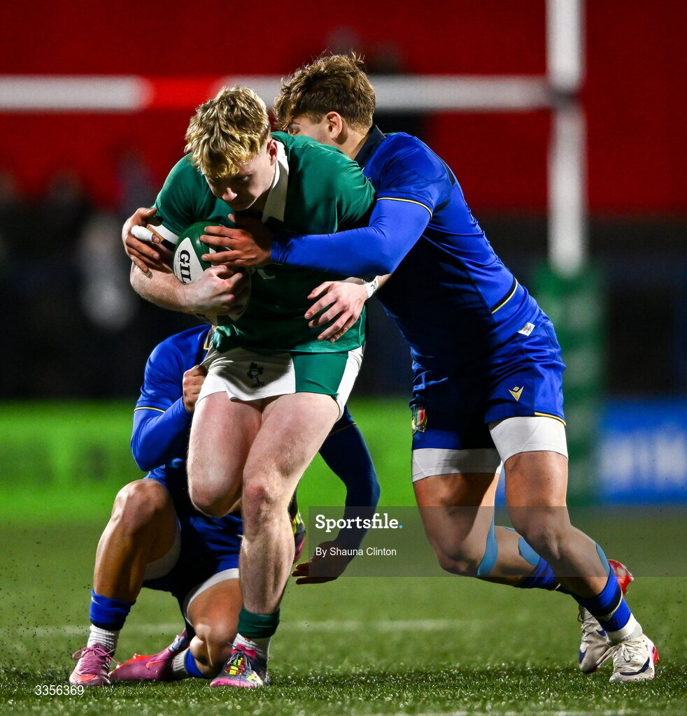 13 February 2026; Rob Carney of Ireland is tackled by Italy players Francesco Braga, left, and Daniele Coluzzi during the U20 Six Nations Rugby Championship match between Ireland and Italy at Virgin Media Park in Cork. Photo by Shauna Clinton/Sportsfile
