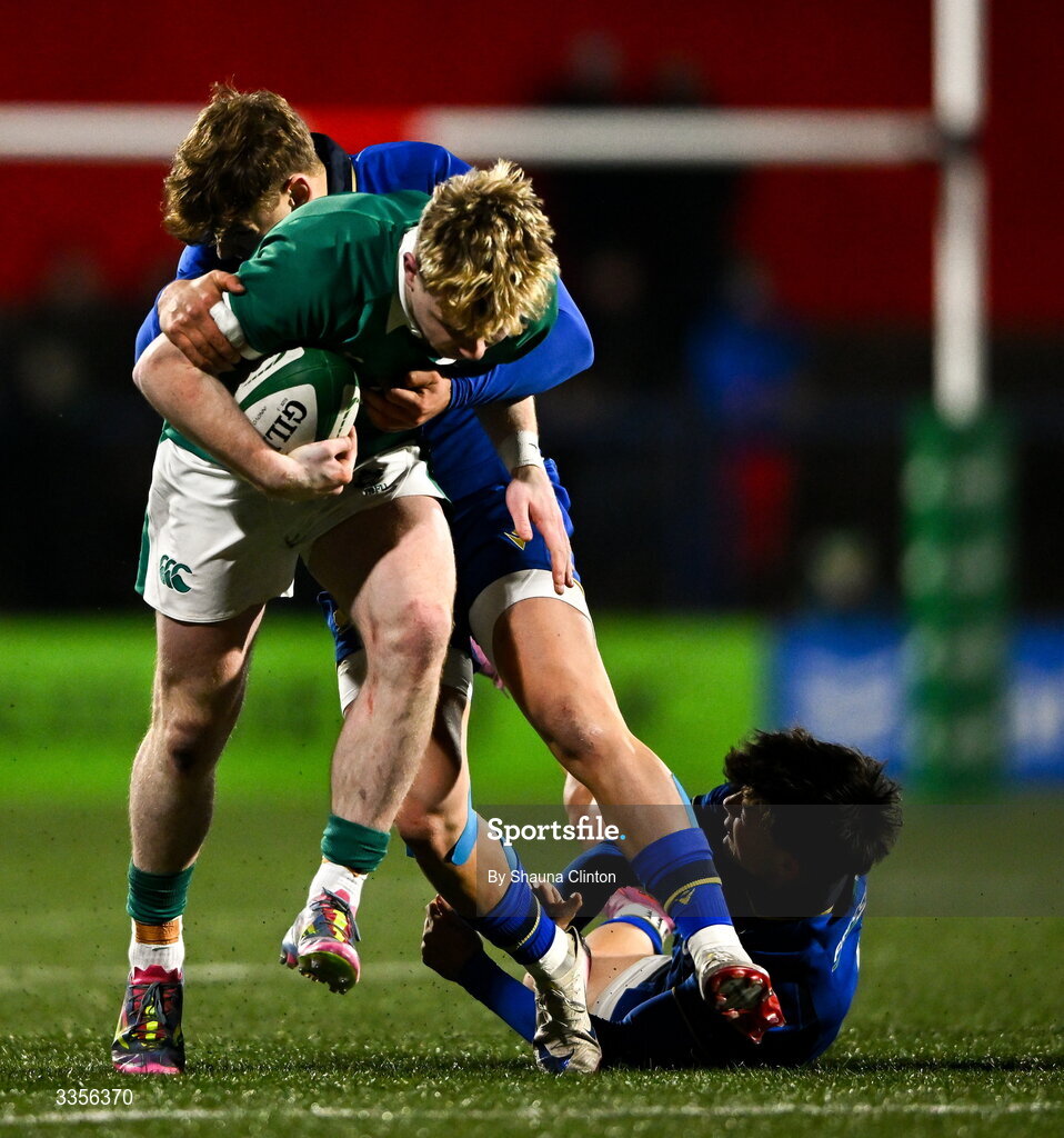 13 February 2026; Rob Carney of Ireland is tackled by Italy players Francesco Braga, left, and Daniele Coluzzi during the U20 Six Nations Rugby Championship match between Ireland and Italy at Virgin Media Park in Cork. Photo by Shauna Clinton/Sportsfile