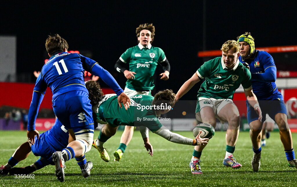 13 February 2026; Derry Moloney of Ireland offloads the ball to team-mate Rob Carney despite the tackle of Nikolaj Varotto of Italy during the U20 Six Nations Rugby Championship match between Ireland and Italy at Virgin Media Park in Cork. Photo by Shauna Clinton/Sportsfile