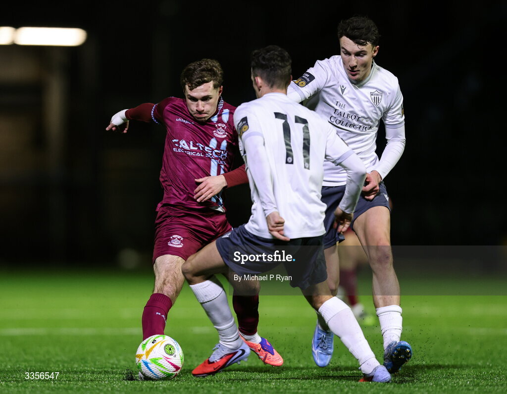 13 February 2026; Mikey Carroll of Cobh Ramblers in action against Jake Doyle, right, and Jamie Wynne of Wexford during the SSE Airtricity Men's First Division match between Cobh Ramblers and Wexford at St Colman's Park in Cobh, Cork. Photo by Michael P Ryan/Sportsfile