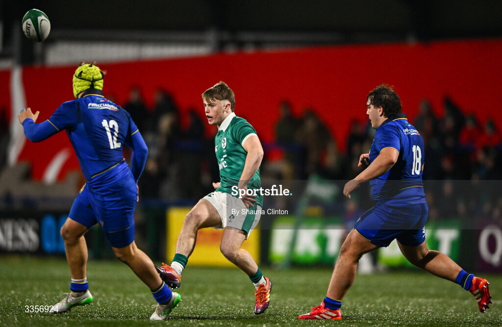 13 February 2026; Charlie O'Shea of Ireland kicks on despite the attention of Italy players Riccardo Casarin, left, and Leonardo Tosi during the U20 Six Nations Rugby Championship match between Ireland and Italy at Virgin Media Park in Cork. Photo by Shauna Clinton/Sportsfile