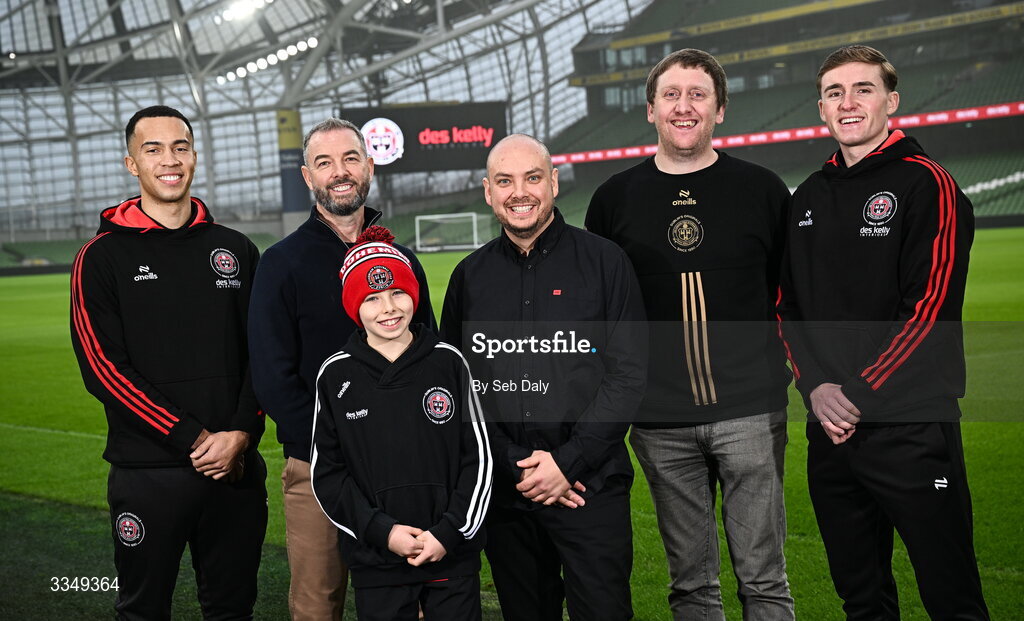 17 February 2026; In attendance at the announcement that Des Kelly Interiors have renewed their sponsorship of Bohemian FC are, from left, Bohemian FC player Douglas James-Taylor, Des Kelly Interiors managing director Greg Kelly, Kaiden Kelly, Des Kelly Interiors director Gerardo Kelly, Bohemian FC chief commercial officer Daniel Lambert, and Bohemian FC player Cian Byrne, at the Aviva Stadium in Dublin. Bohemian FC is delighted to confirm a three-year extension to our long-standing partnership with Des Kelly Interiors as the club’s main sponsor which is now agreed until the end of the 2028 season, a continuation of a relationship that now spans six decades. The renewed arrangement will see the Des Kelly Interiors name continue to be proudly displayed on the Bohs men’s teams home kit as well as adorning the jerseys of the club’s boys academy teams, extending their commitment to the wider Bohemian family. Photo by Seb Daly/Sportsfile